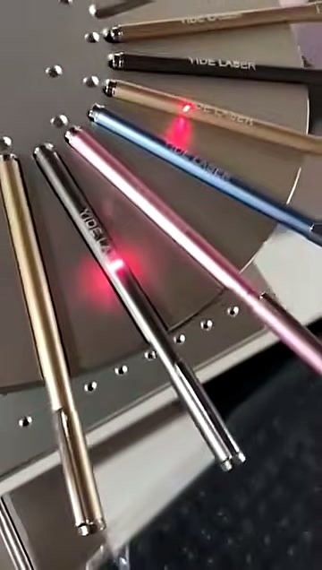 Batch metallic pens on rotary plate being marked (SKU ask)