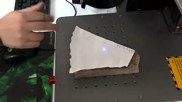 Blue aiming laser on stone on marker bed (SKU ask)
