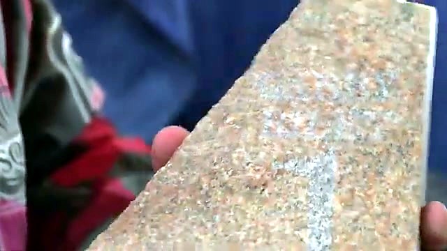 Finished engraved granite nameplate in hand (SKU ask)