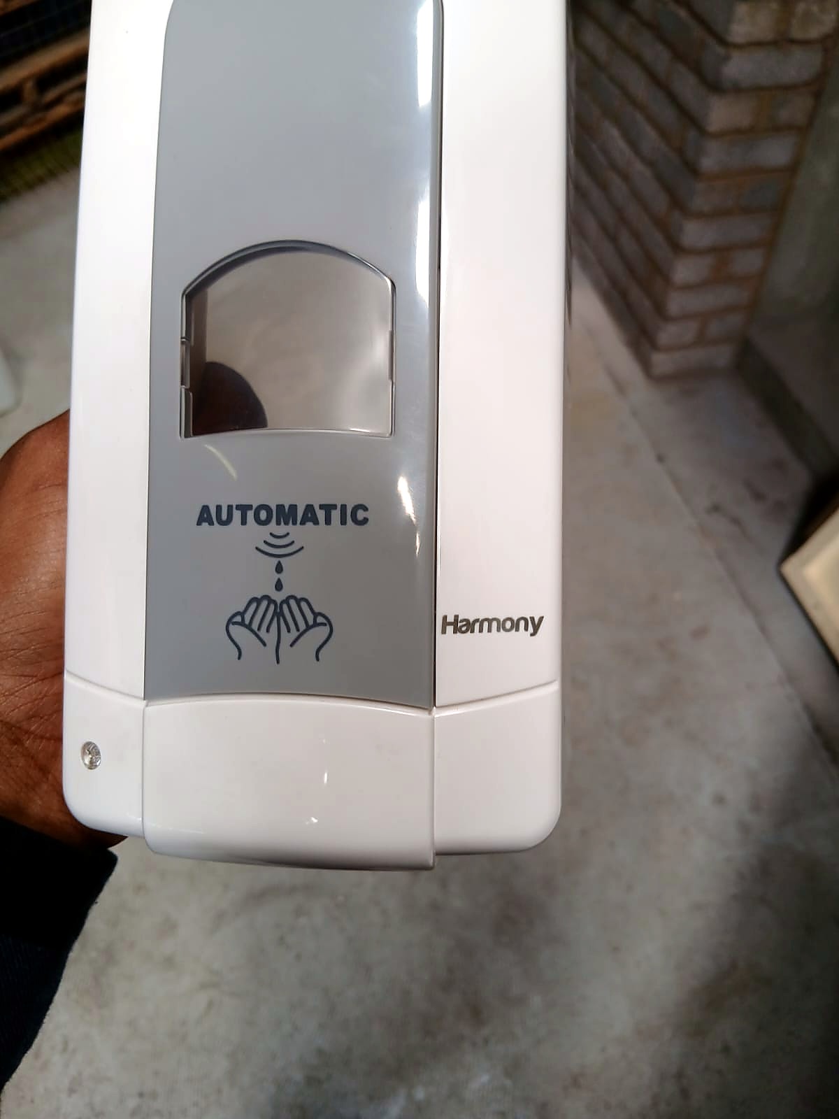 LLM-F20 sample output: text and hand icon marked on a white/grey plastic automatic soap dispenser (customer photo)