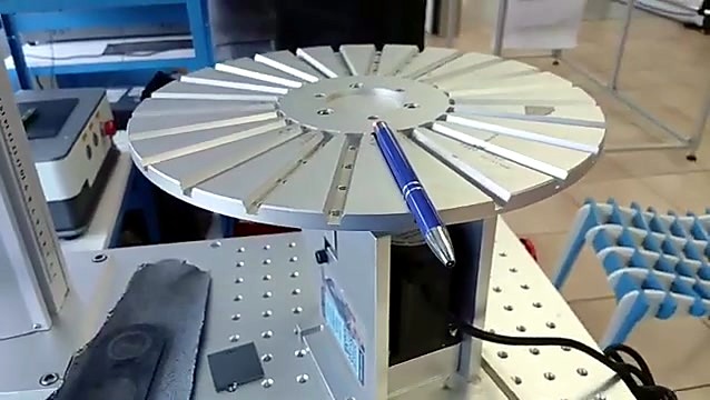 Painted aluminium pen on slotted fixture under marker