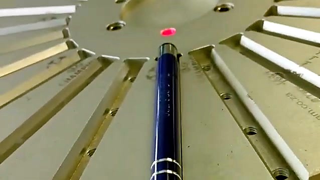 Red aiming dot positioned on pen