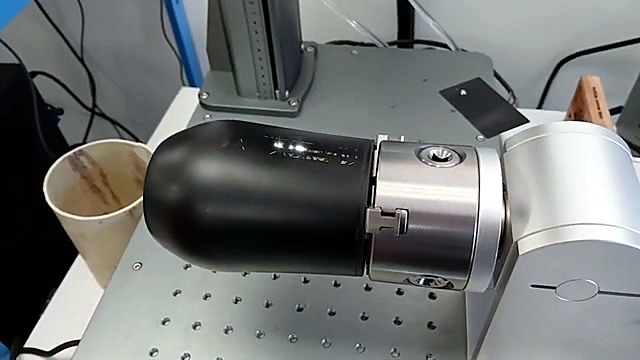 Rotary chuck holding blank black aluminium bottle (SKU ask)