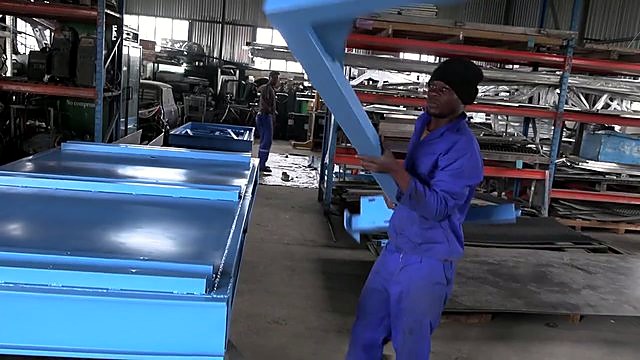Workers assembling light-blue plasma frame (SKU ask)