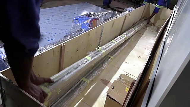 Unboxing long rail components from wooden crate (SKU ask)
