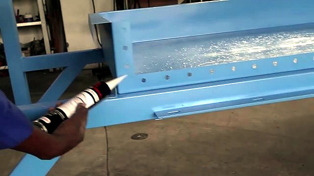 White sealant bead on blue water-basin corner joint (SKU ask)
