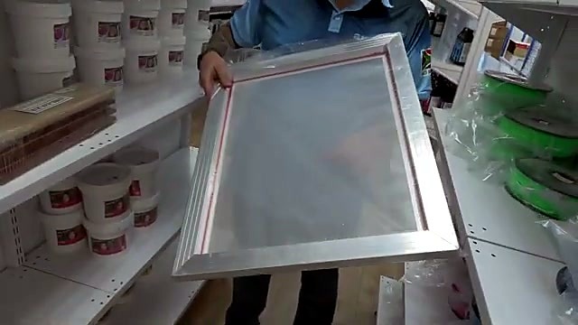 Presenter holding large aluminum silk screen frame (SKU ask)