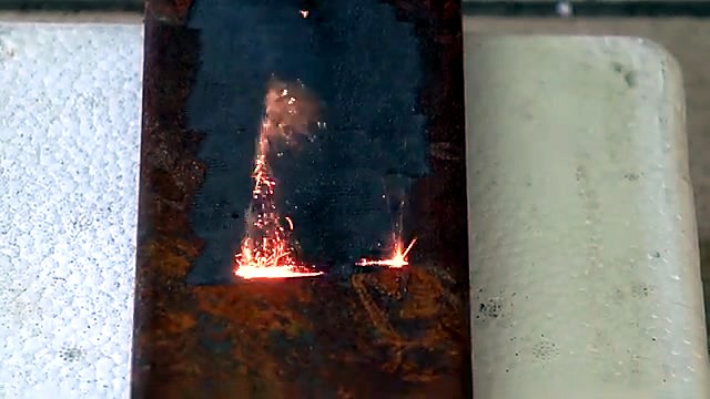 Handheld torch cleaning sparks on plate (SKU ask)