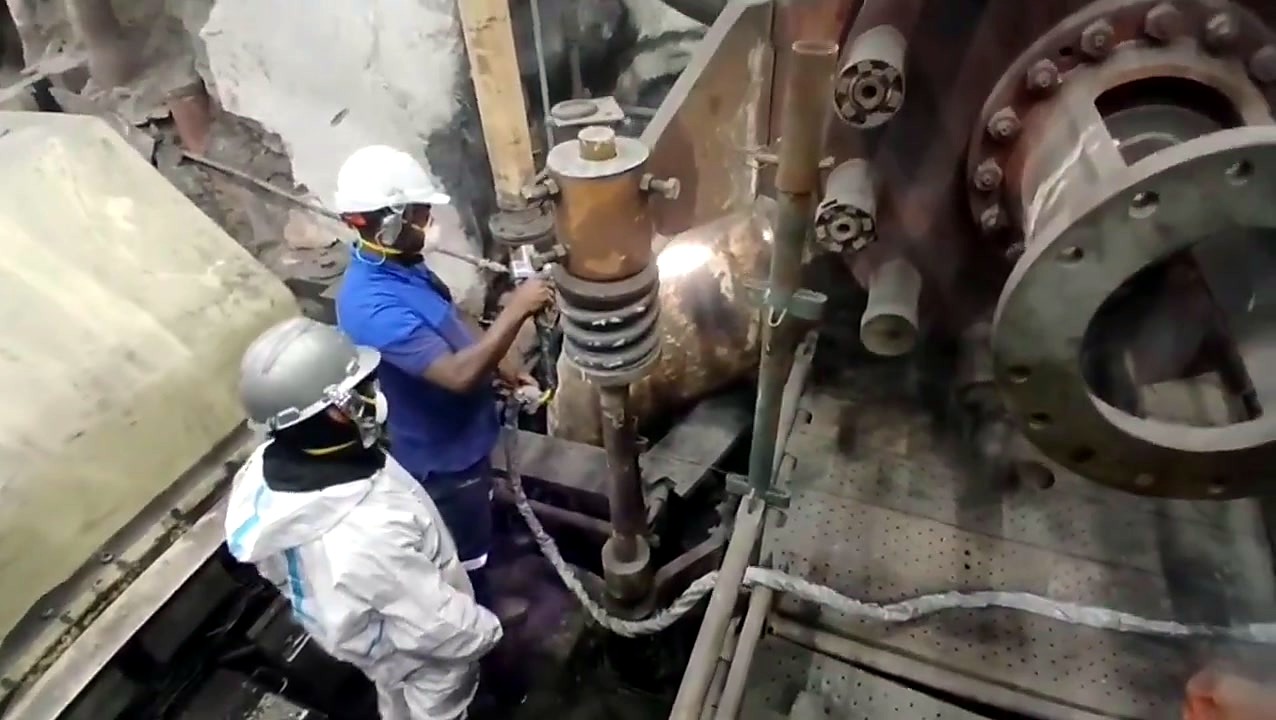 Two workers prep laser job on platform (SKU ask)