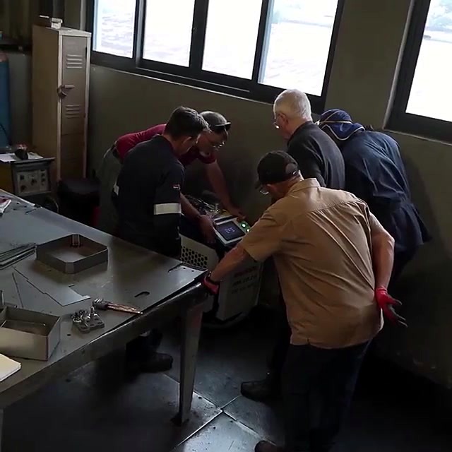 Training group around Versatile cabinet touchscreen (wattage open)
