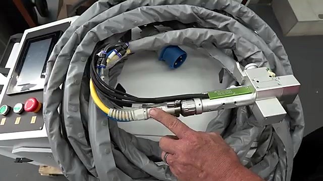 Hand pointing QBH connection on coiled umbilical (wattage open)