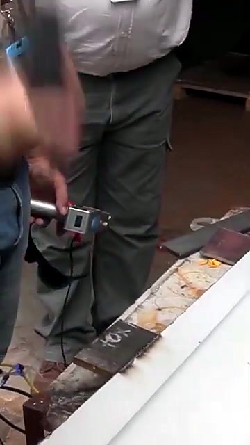 Handheld RustOff torch on corrugated metal sheet (SKU ask)