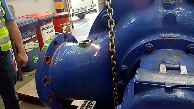 Hi-vis operator + handheld torch on blue casting (SKU ask)