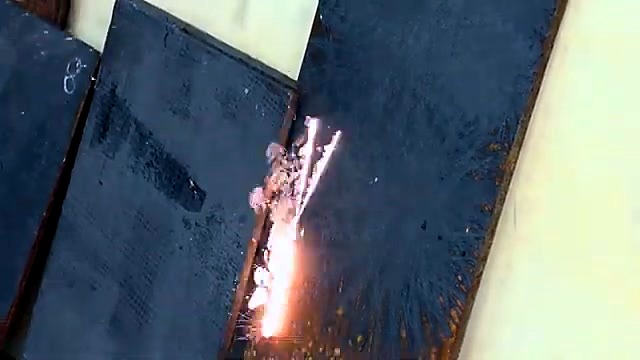 Handheld torch cleaning sparks on metal plate (SKU ask)