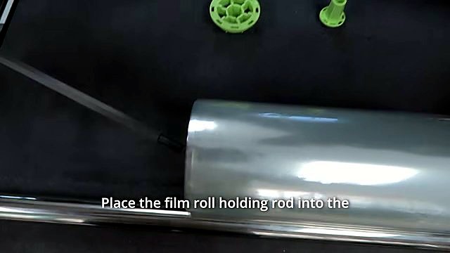 Film-roll rod into clear roll + lime-green core adapters (SKU ask roll)