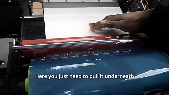 Blue film on green core pulled under red rubber roller (SKU ask roll)