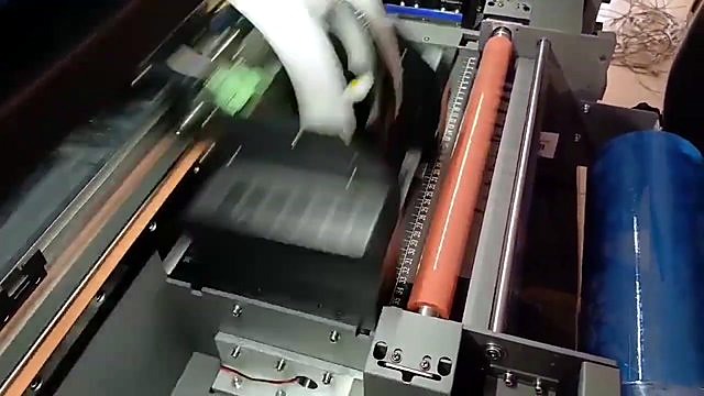 Blue B-film roll + orange roller + carriage (laminator path; SKU ask)