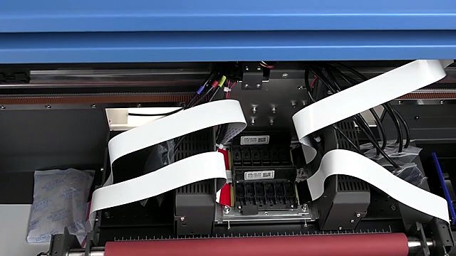 White ribbon cables over red/pink roller path (SKU ask)