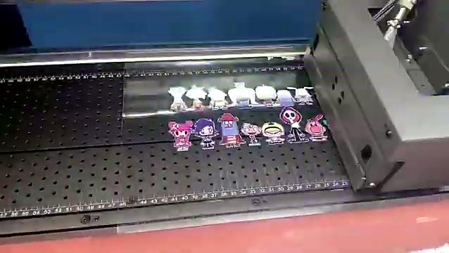 Two rows of full-colour cartoon character stickers printed on UV-DTF film on the vacuum bed