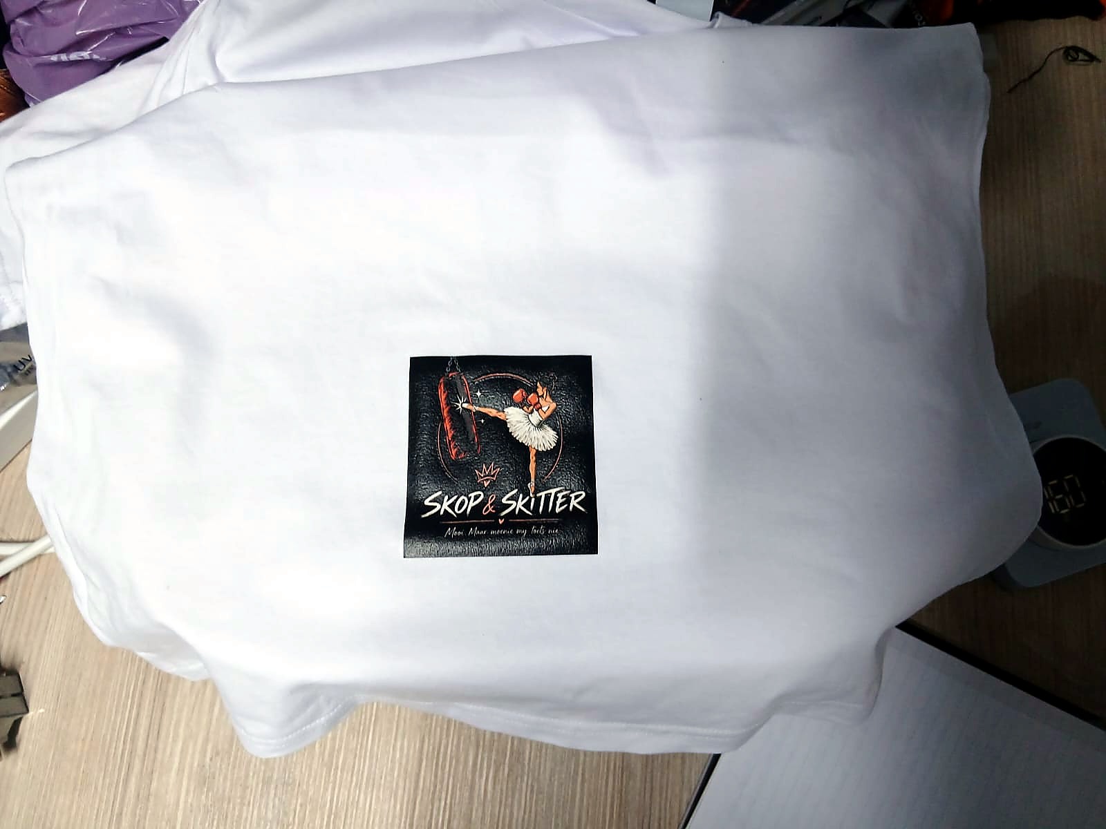 F-UVDTF/A3 (as sent with the video): square full-colour 'Skop & Skitter' ballerina-kickboxer print applied to a white T-shirt; sent as a sample for the UV-DTF video, but the print method isn't visible in the photo (staff still)