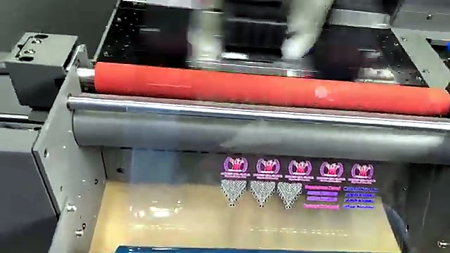 Red tension roller over clear film exit (SKU ask)