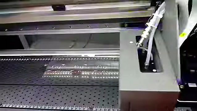 Carriage + blue UV cure glow over vacuum bed (SKU ask)