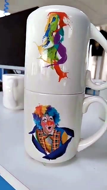 Clown + splash stickers on stacked white mugs (SKU ask)