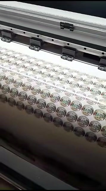 Pinch rollers over dense circular sticker roll (SKU ask)