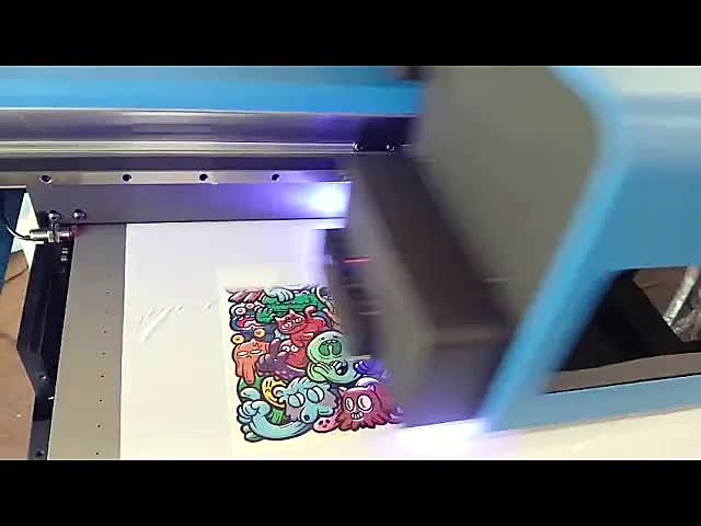 F2-6090C UV carriage with violet UV LED glow over a colourful doodle print