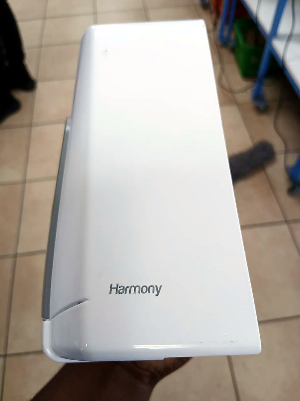 F2-6090C UV print: dark-gray Harmony wordmark on white ABS plastic (staff still)