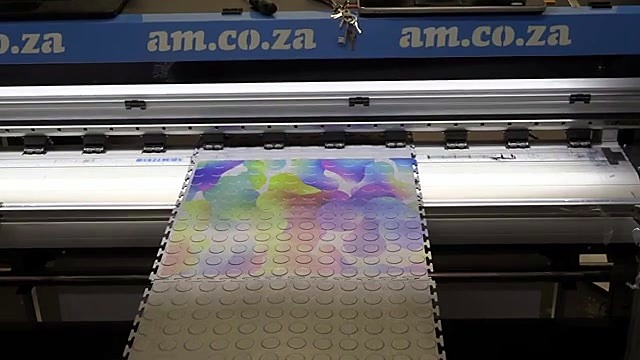 Nearly finished colourful mat on bed (SKU ask)