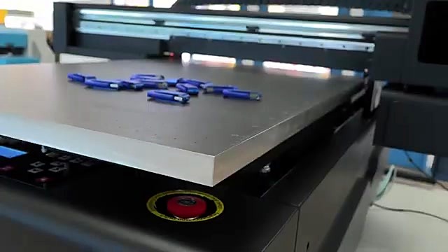 Blue USB flash drives scattered on vacuum bed + estop (SKU ask)