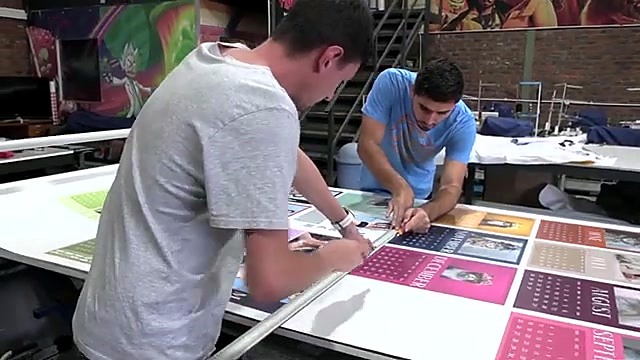 Operators trimming printed calendar sheet (SKU ask)