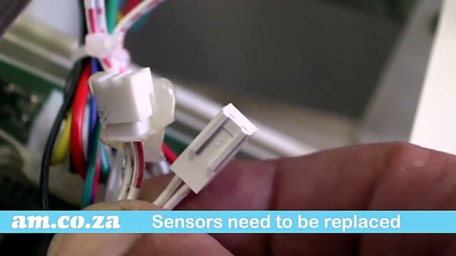White 2-pin sensor connectors in hand (SKU ask)