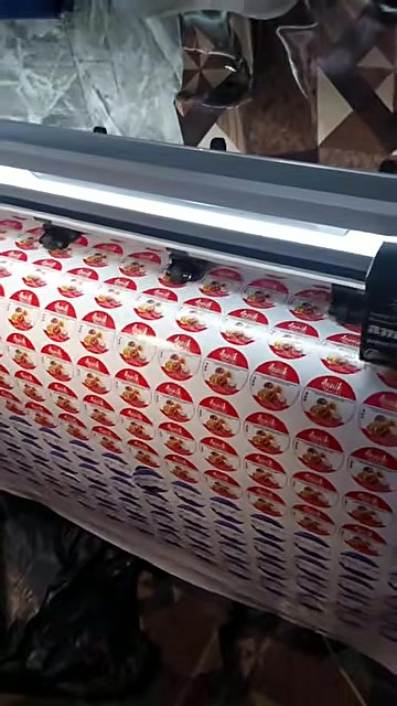 Pinch rollers + LED bar feeding printed sticker roll (SKU ask)