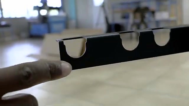 Black roll-holder bracket with semi-circle cutouts (SKU ask)