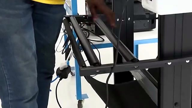 Studio stand + rear roll holders beside operator (SKU ask)